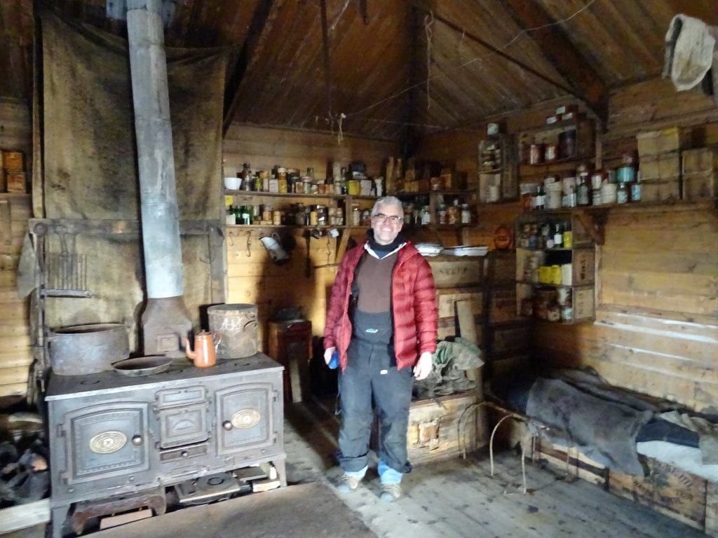 Adrian Howkins poses in an Antarctic hut