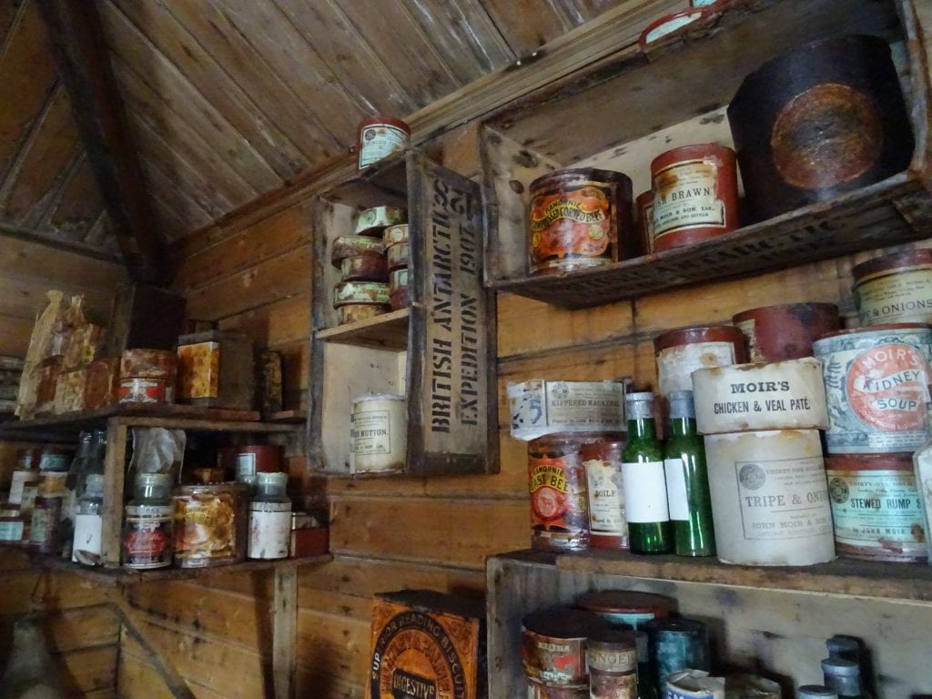 Photo of shelves in Shackleton's hut, stacked with tins and provisions