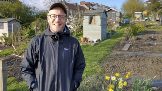 Portrait of Rich wearing glasses, a cap, a waterproof, at his allotment